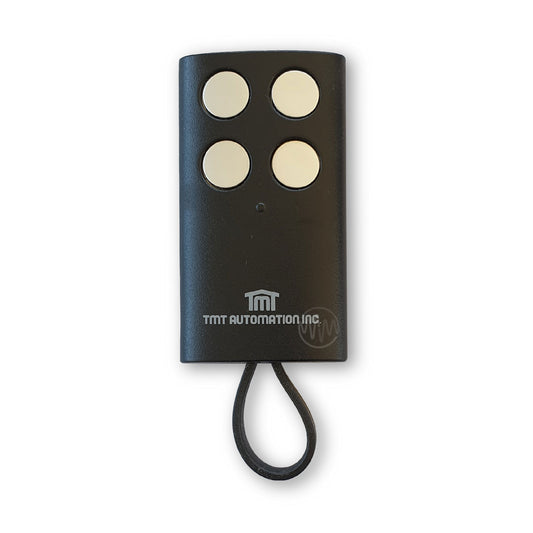 TMT Automation Inc branded black gate remote with 4 round silver buttons & rubber key ring attachment